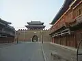 Shi-Li Song Street and the city gates of Zhoucheng. Zhoucheng was initially constructed in the year 1000 AD. However, it was dismantled after the Anti-Japanese War, and the city gates and walls shown in the image have all been reconstructed in modern times.