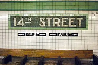 IND trim line, mosaic name tablet, and directional tile captions