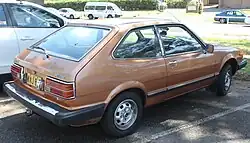 Rear three-quarter view of a three-door hatchback automobile.