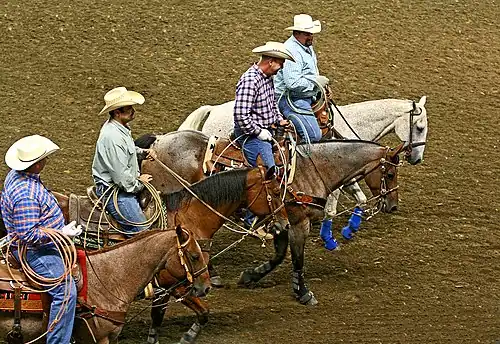 Riders carrying modern lassos for competition in team roping at the Kentucky State Fair, 2008