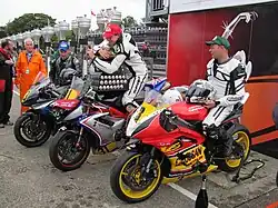 Winners Presentation 2012 Senior Manx Grand Prix – Andrew Soar (43) 750 cc Suzuki, John Simpson (31) 675 cc Triumph & Wayne Kirwan (4) 600 cc Yamaha TT Grandstand Friday 31 August 2012