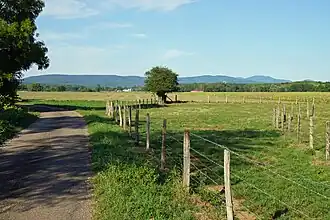 The Roye plain stretches between the village and La Côte. The Vosges mountains are visible on the horizon.