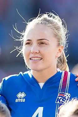 Headshot of Glódís Perla Viggósdóttir. She is a young woman with blonde hair, wearing a sports jersey.