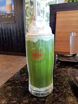 Matcha nitro cold brew topped with whipped cream