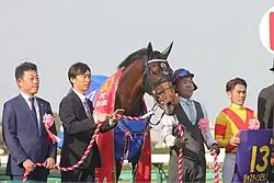 Justin Milano with his connections right after winning Satsuki Sho.