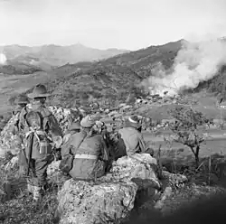 Image 28Soldiers from 3 RAR watch as a Korean village burns in late 1950 (from History of the Australian Army)