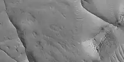 Close view of ridges, as seen by HiRISE under HiWish program. This is an enlargement of a previous image. A small mesa in the image displays layers.