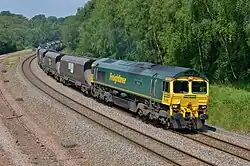 A Class 66 locomotive hauling wagons towards the camera