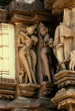 Apsara (right) exposes her yoni