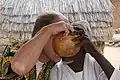Friendship. Draining a gourd with millet beer together at the market, Mogodé, 1998.