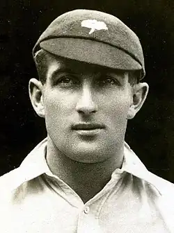 A headshot of a cricketer in a cap
