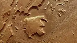 The large block in this image was separated from the nearby elevated areas by tectonic activity in Mars' past.[33]