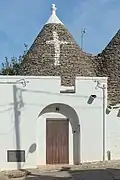 Trullo with a cross painted on the roof