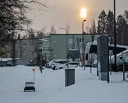 Delivery robot used by Alepa grocery chain on its way along the sidewalk in Ala-Malmi, Helsinki (Winter 2023)