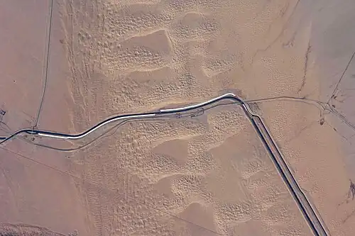 This image captures about 15 kilometers (9.3 mi) of the All-American Canal just west of Yuma, Arizona; photo is taken of the southern section of the Algodones Dunes