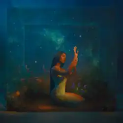 A woman holds both hands up towards a light shining on her; she sits in an underwater cube that reflects the cosmos.