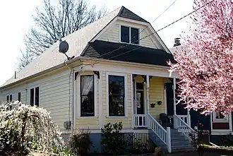 Photograph of the Armbruster Cottage, a simple, one-story house