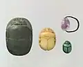 Scarab beetles were one of the most common material objects made by the ancient Egyptians. These scarabs, from the Middle Kingdom, were likely used as jewelry, specifically amulets. The scarab beetle is symbolic of Khepri, the Egyptian sun deity who represents creation and rebirth[9].