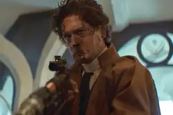 Syril lowers his gun