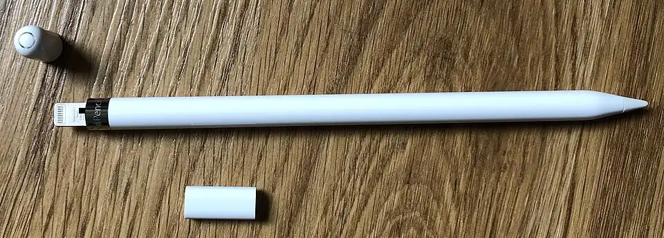 The first generation Apple Pencil, with its Lightning connector exposed. The accompanying female-to-female Lightning adapter is below the Pencil.