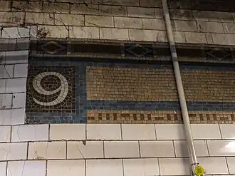 Original mosaic trim remnant in the southbound fare area