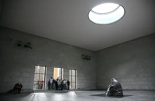 Image 16 Neue Wache Photo credit: Daniel Schwen The interior of the Neue Wache, the central memorial of Germany for victims of war and tyranny. Located in Berlin, the building was originally built as a guardhouse, and has been used as a war memorial since 1931. The statue, Mother with her Dead Son is directly under the oculus, and so is exposed to the rain, snow and cold, symbolising the suffering of civilians during World War II.