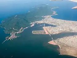 Aerial view (looking east) of the mouth of the Hàn River, which empties into Da Nang city harbor. Thuận Phước Bridge crosses the mouth.
