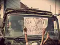 Students protests against the imposition of vat in their tuition fees by upholding the placard in front of Army vehicle.