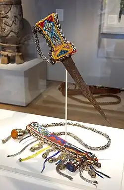 Beaded sword and Sheath, Nigeria, Yoruba people; beads, metal, fabric, coins, brass, cowry shells, leather – Chazen Museum of Art