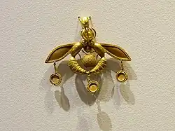 The Malia Pendant, an iconic Minoan jewel; 1700-1600 BC; gold; width: 4.6 cm; from Chrysolakkos (gold pit) complex at Malia; Archaeological Museum of Heraklion[10]