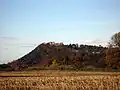 Beeston Castle viewed from the south, built on a rocky summit 110&nbsp;m (360&nbsp;ft) above the Cheshire Plain