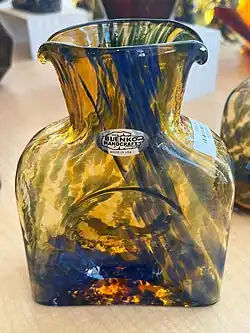 gold with blue square-ish bottle with two spouts