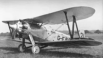 black and white photograph of a Bristol Type 101 aeroplane on the ground in a field. it looks to be about to take off with the propeller spinning.