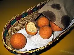 Fried balls of dough in a basket.