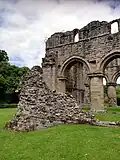 The south west corner of the church, showing all that remains of the abbey's aisle walls and a section of foundation.
