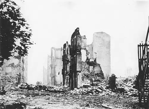 Guernica in ruins, with only a few partially-demolished buildings standing