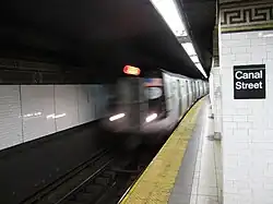 A "J" train entering the Nassau Street Line station at Canal Street