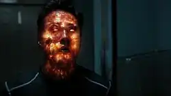 The fiery Extremis virus inside the character Chan Ho Yin begins to explode, his face glowing orange