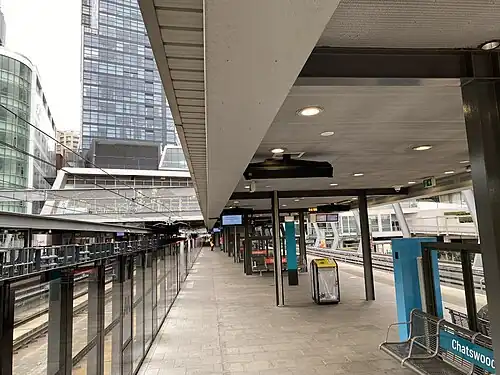 Picture of Chatswood station. It consists of a metro train at a platform with platform screen doors.