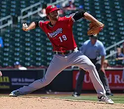 A baseball player in red and gray
