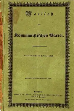A decorative border and ornate text reading "Manifest der Kommunistischen Partei." on darker-than-white paper.