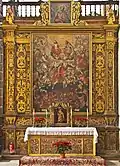 Altar in Iglesia de la Concepción, Santa Cruz de Tenerife. Top: Trinity; Mid-top: Mary, John the Baptist, Holy family; Mid: archangel Michael; Lower: Saints interceding; Bottom: souls undergoing fiery purgation, still with worldly attachments (shackles) and venial sins (snakes).