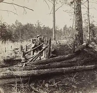 Lt George Chancellor Co E 9th Virginia Cavalry on the Wilderness Battlefield, standing at some Confederate breastworks near Palmer's field on the Orange Turnpike.