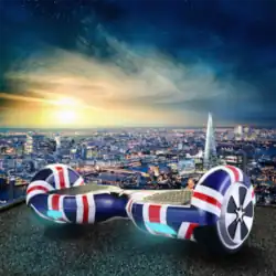 A hoverboard painted as the flag of the United Kingdom is pictured, with the skyline of London behind it as the sun sets down.