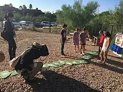 Students being photographed as they demonstrate new playground.