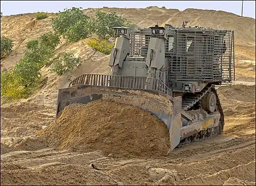 IDF Caterpillar D9R pushing soil for an earthworks.