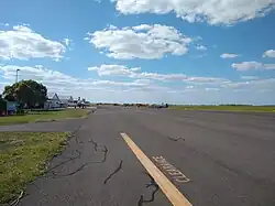 A view of the Dalby Airport apron from the fuel pumps, looking West. Runway 13/31 runs parallel to the apron, while 04/22 is perpendicular and is at the western end of the apron.