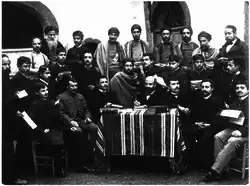 Educator David Cazes (beyond the desk) and a group of teachers and rabbis, Tunis, 1887.