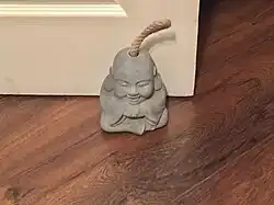 A decorative concrete doorstop
