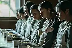 A group of Native American children are served a meal at an American Indian boarding school